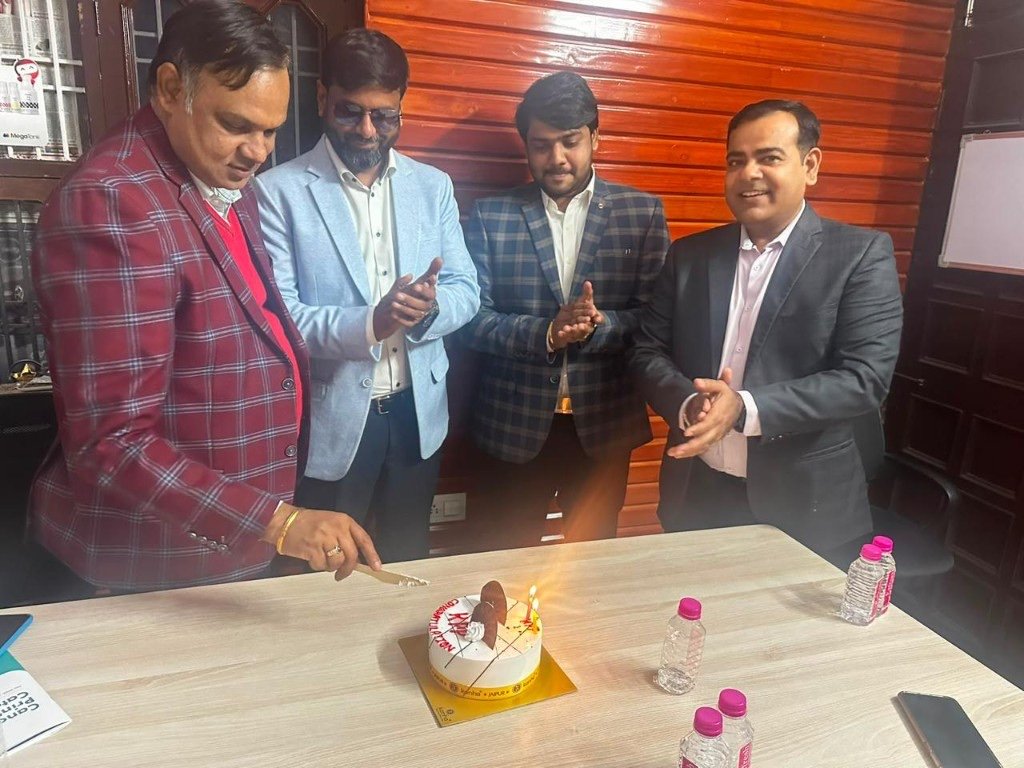 Khandelwal Photo Print team celebrating a milestone with a congratulations cake